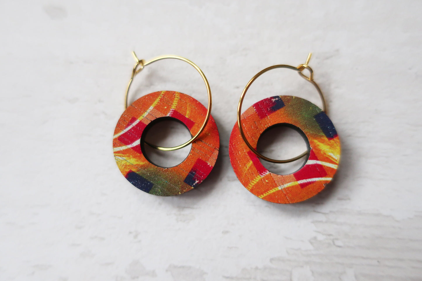 Colorful hoop earrings on a light gray background