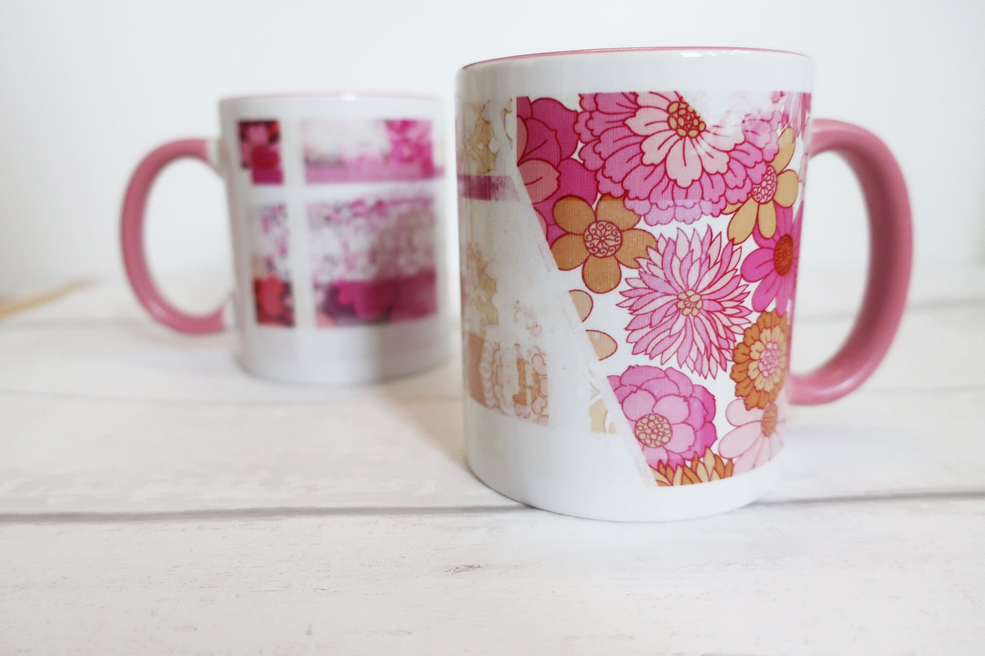 Two floral-patterned mugs on a white surface