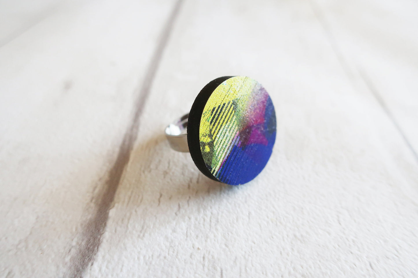 Ring with a colorful design on a white fabric background