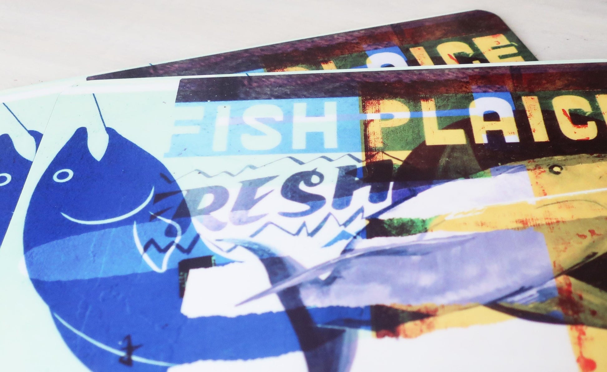 Collage of placemats with a fish graphic and text on a white background