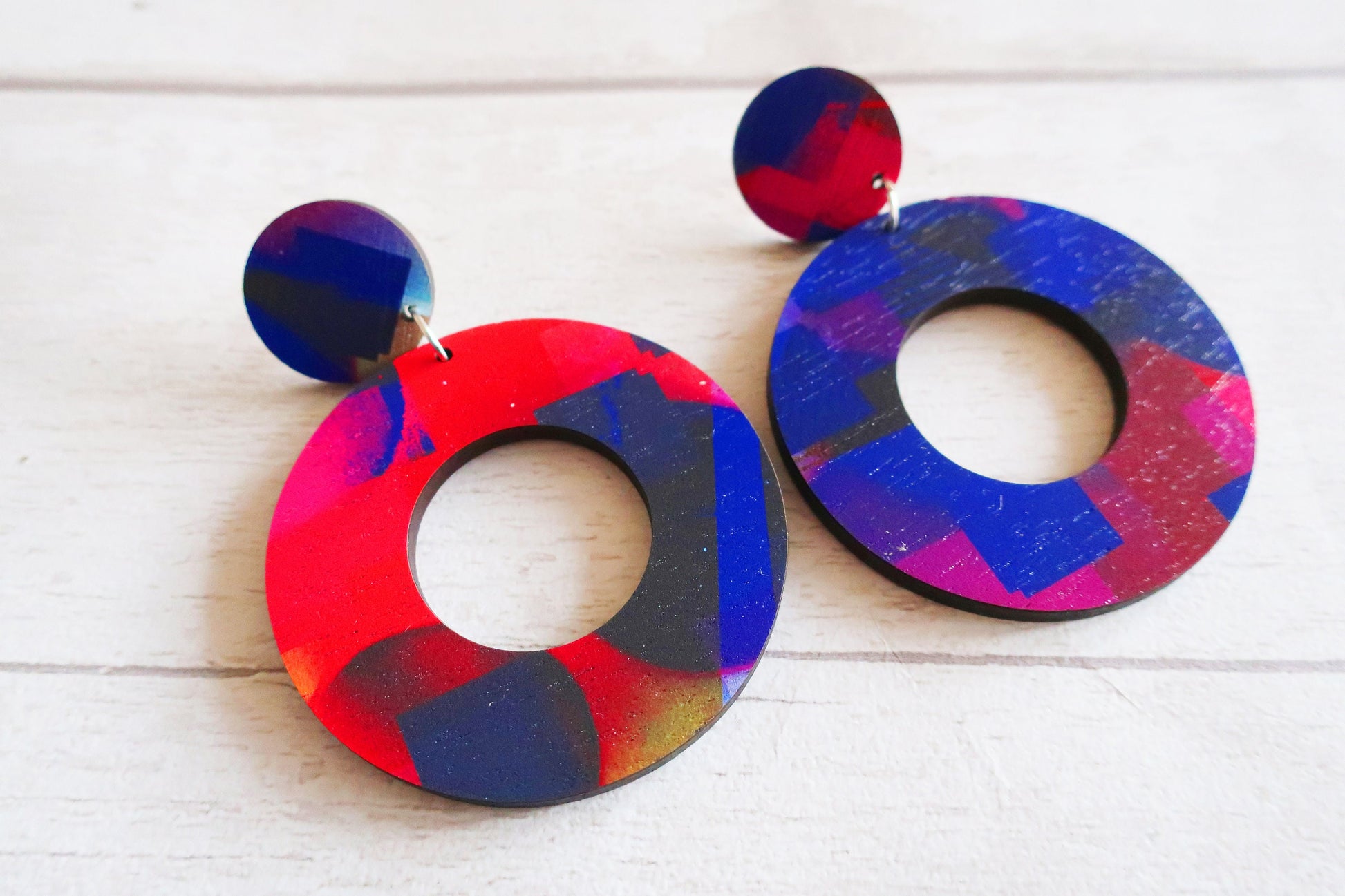 Colorful circular earrings on a white background