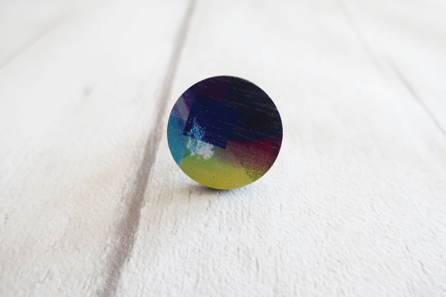 Round colorful ring on a white fabric background