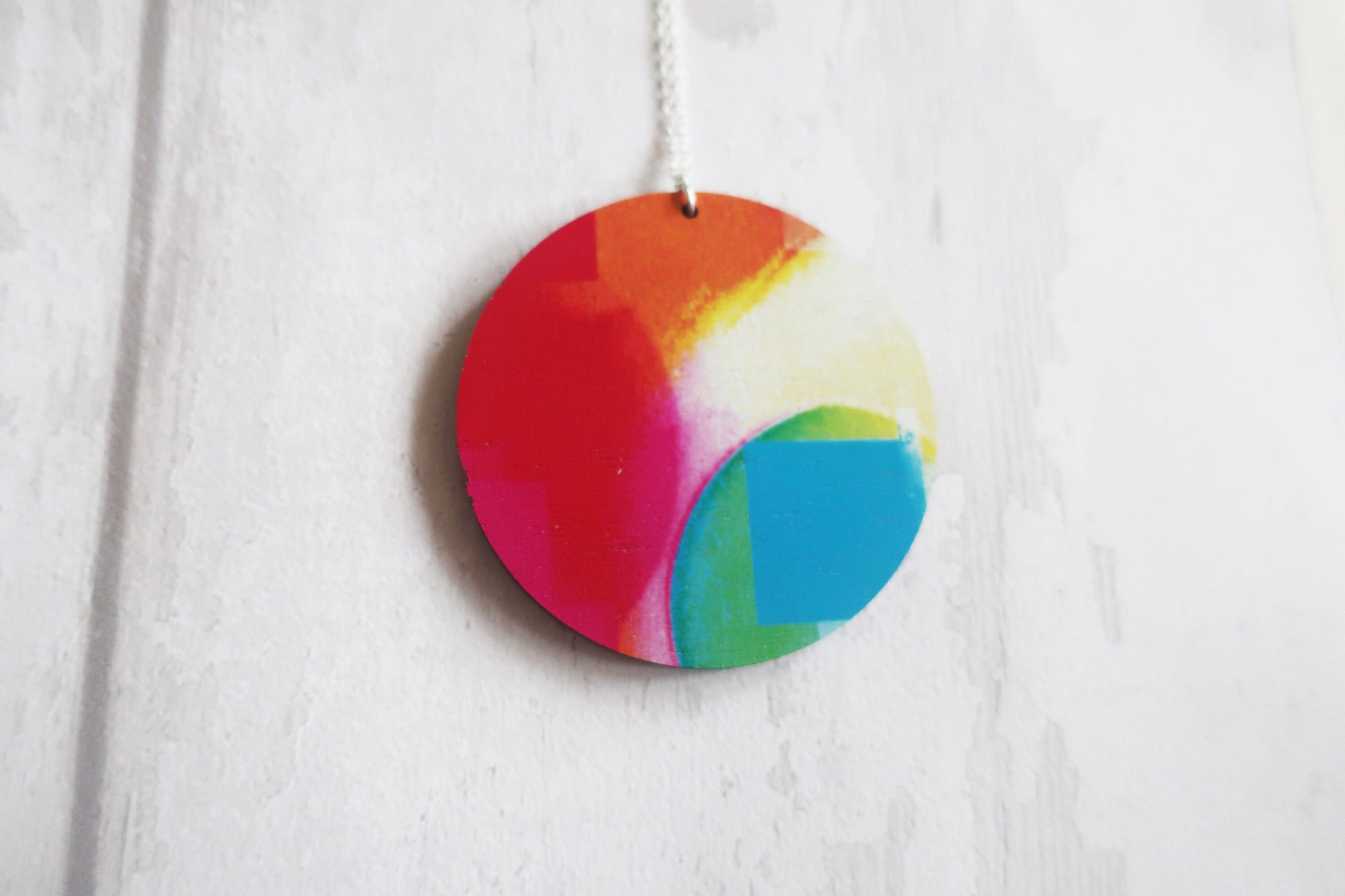 Colorful round pendant hanging on a white background