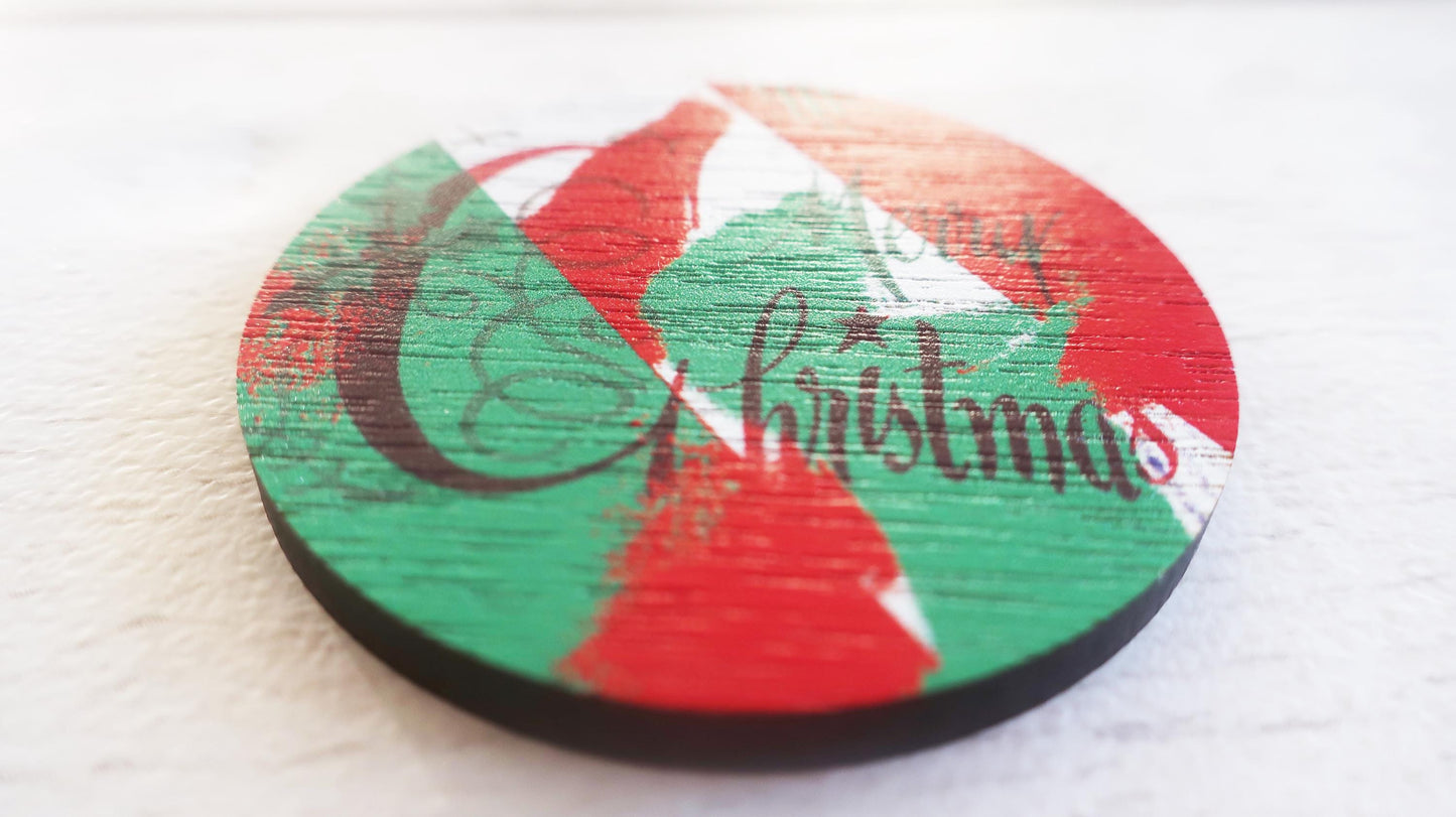 Round Christmas-themed badge with red and green design on a white background
