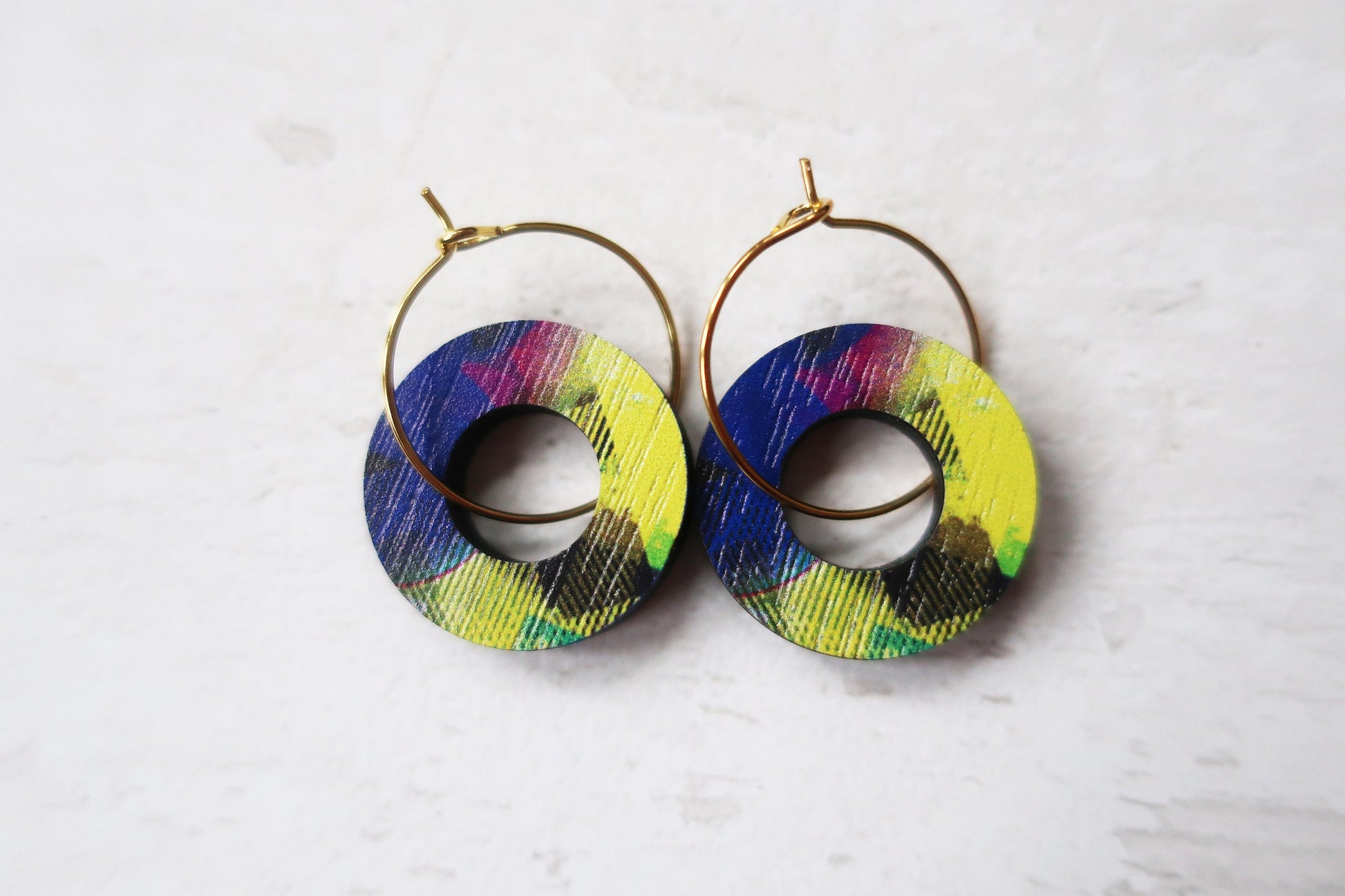 Colorful hoop earrings on a light gray background