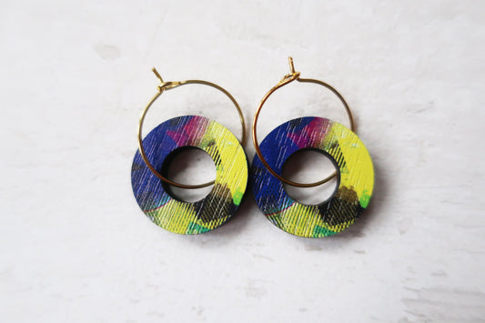 Colorful hoop earrings on a light gray background