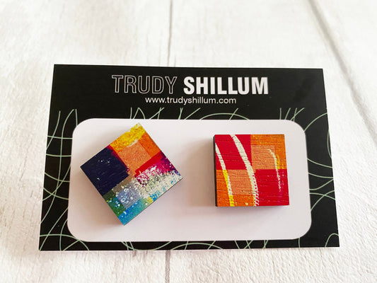 Two small earrings on a card  featuring 'Trudy Shillum' branding.
