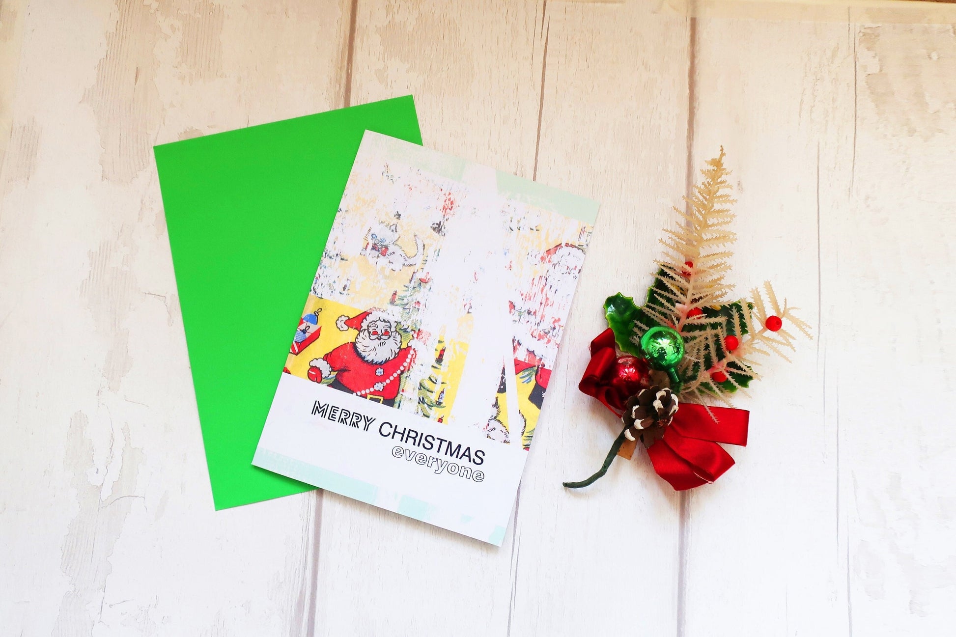 Santa Christmas card with a decorative tree and red bow on a wooden surface