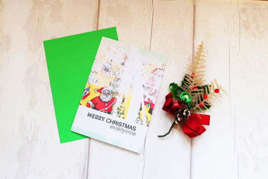 Santa Christmas card with a decorative tree and red bow on a wooden surface