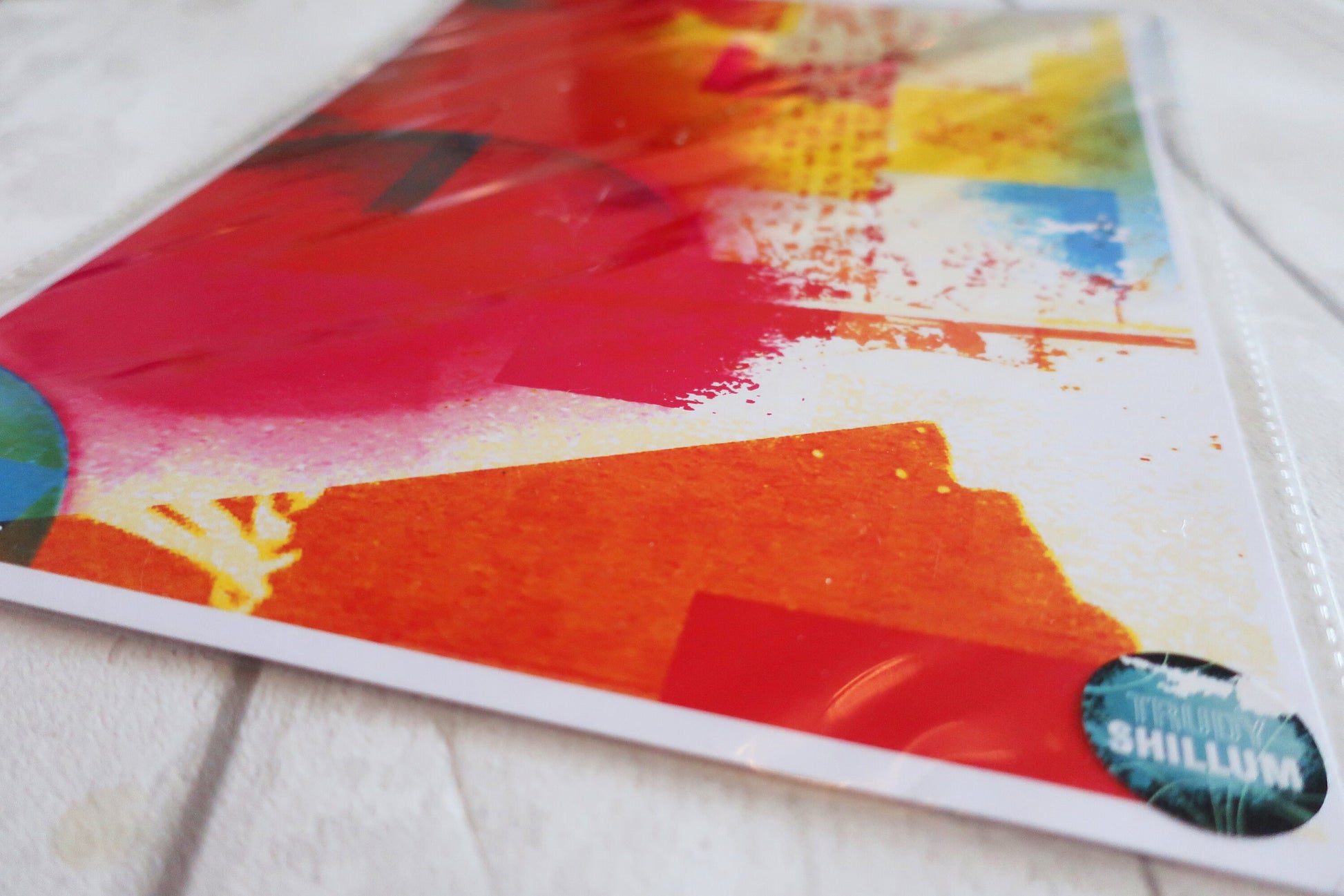 Colorful abstract art print  on a white surface with 'Shillum' branding.