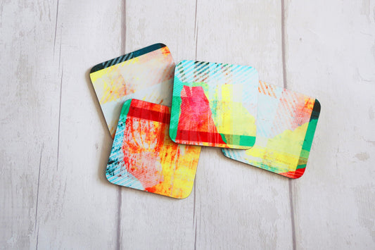 Colorful abstract coasters on a light wooden surface