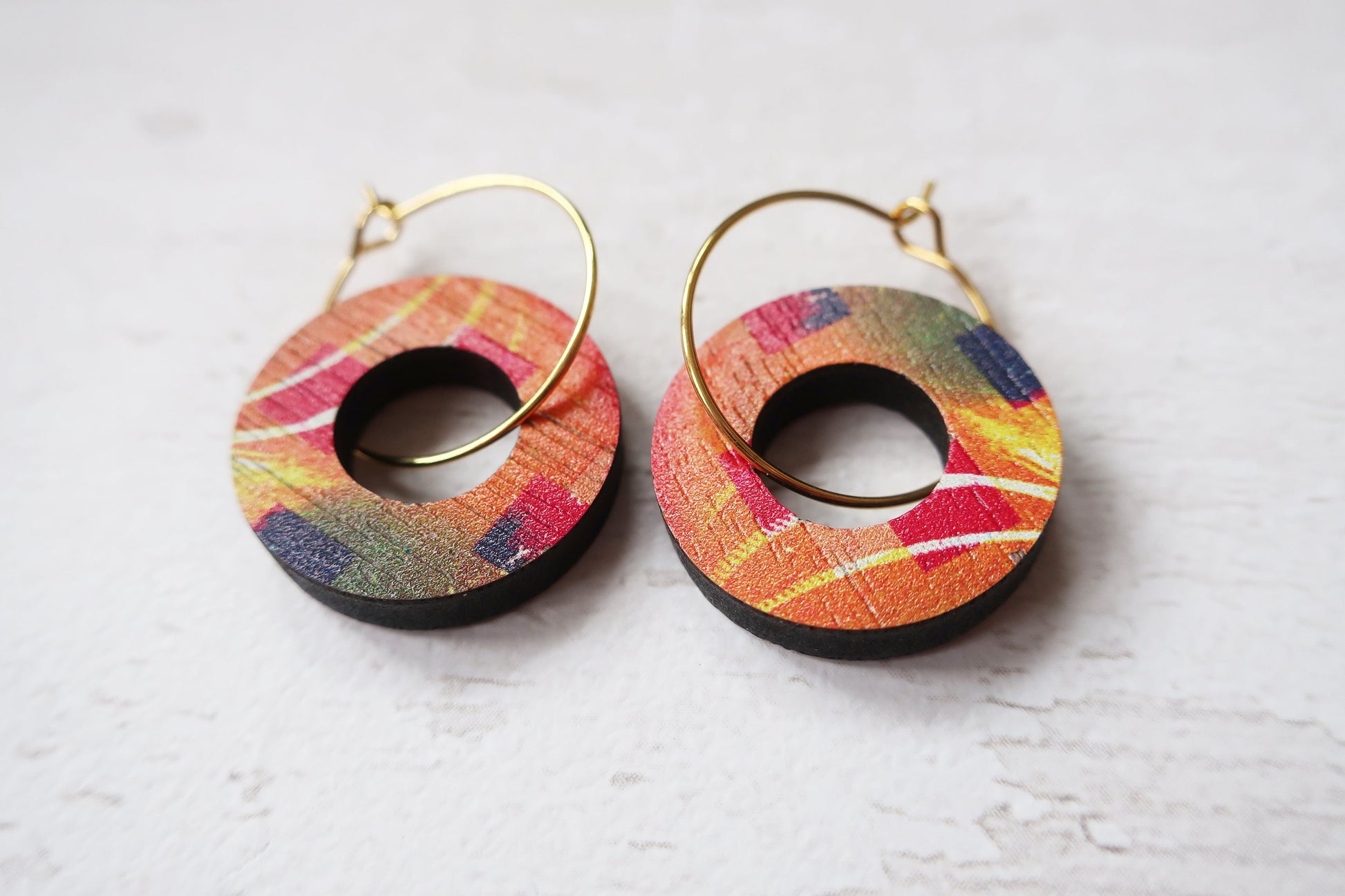 Colorful hoop earrings on a light gray background
