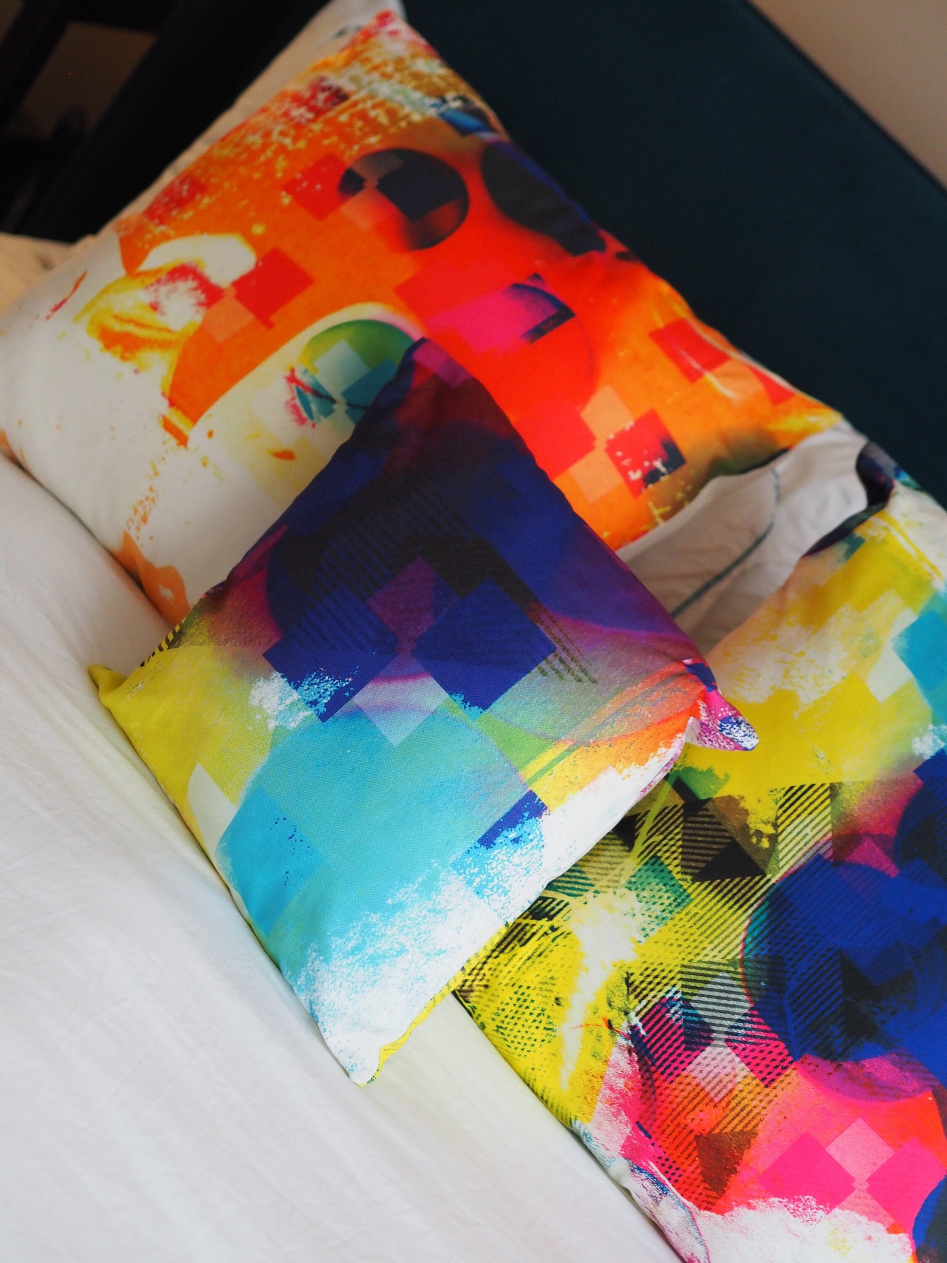 Colorful abstract cushions on a white surface