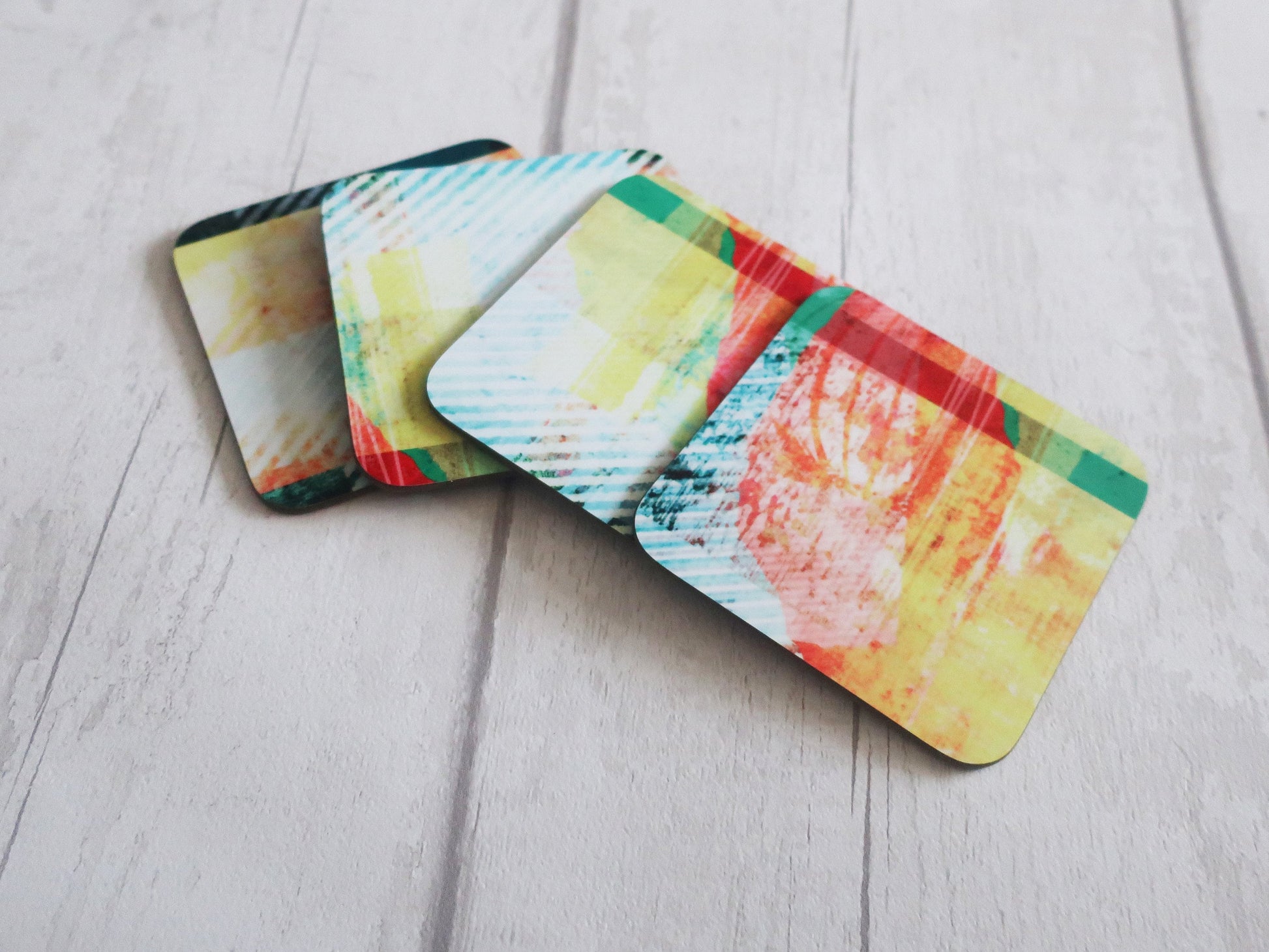 Set of colorful coasters on a light wooden surface