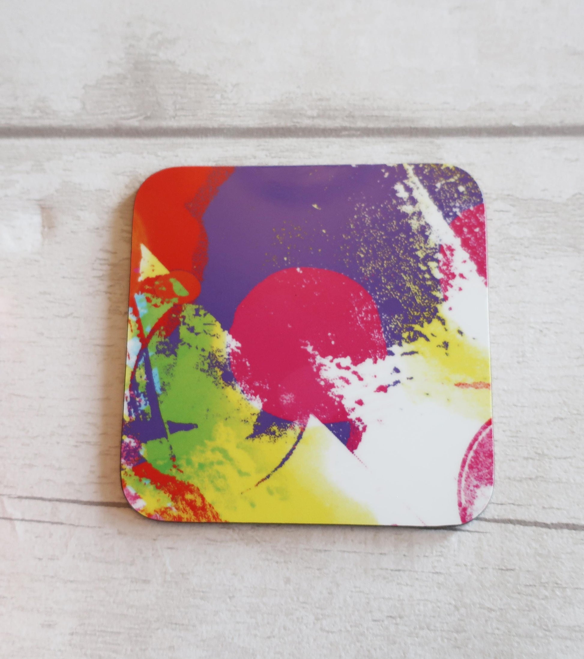 Colorful abstract coaster on a wooden surface