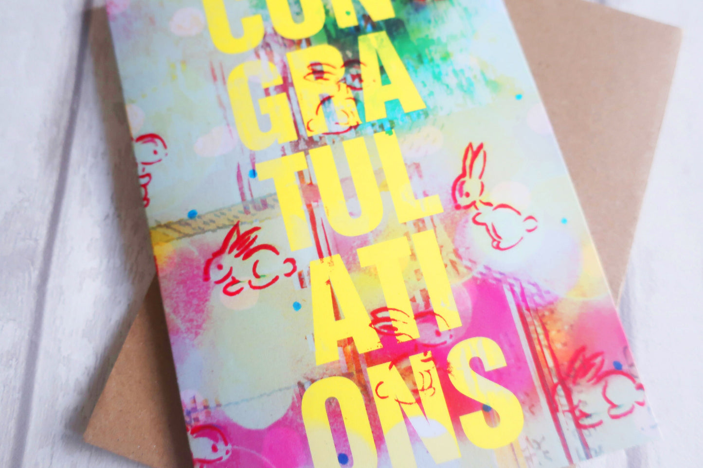 Colorful 'Congratulations' card with cartoon characters on a white background