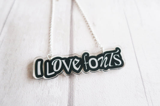 Necklace with 'I LOVE FONTS' pendant on a white background