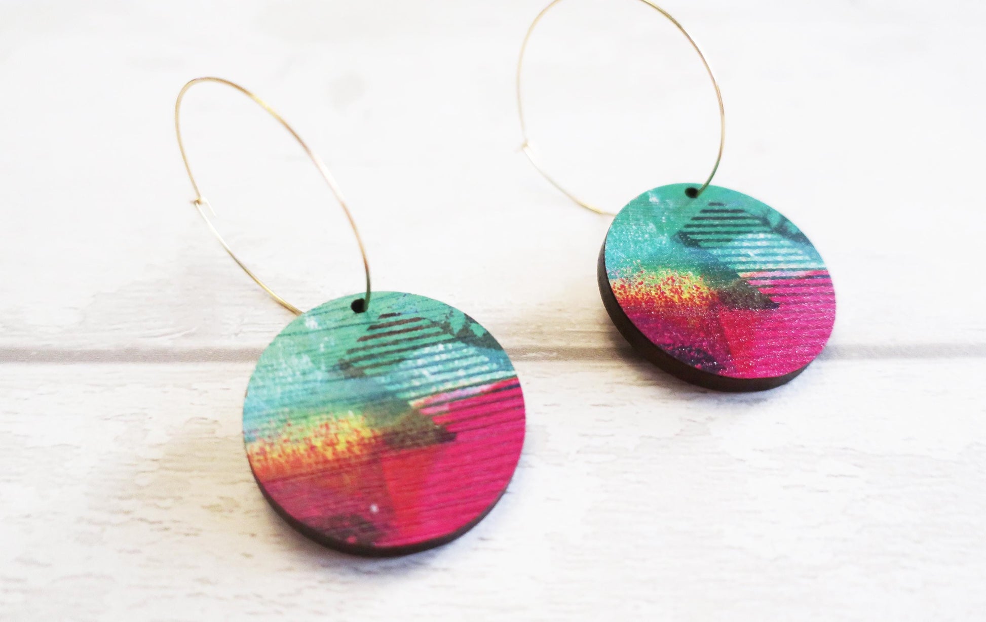 Colorful circular earrings on a white background