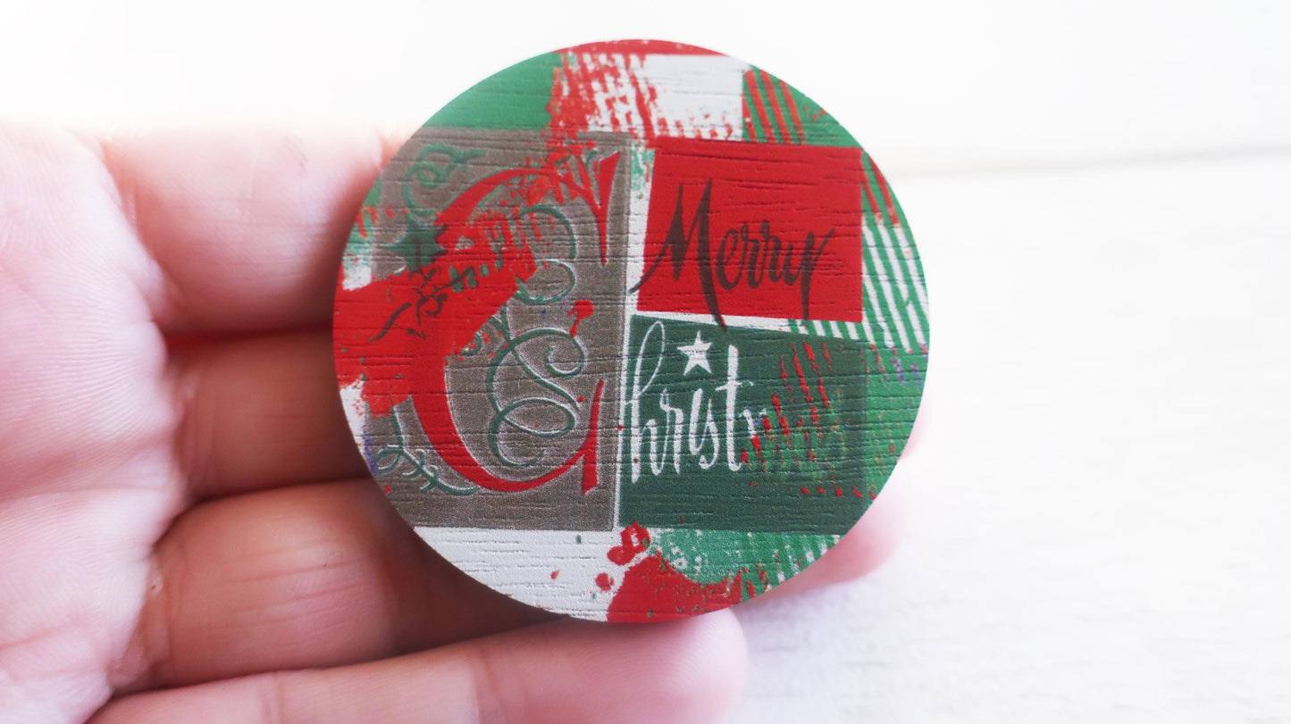 Round decorative badge with Christmas-themed pattern held in a hand