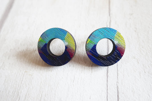 Pair of round earrings with colorful striped design on a white background