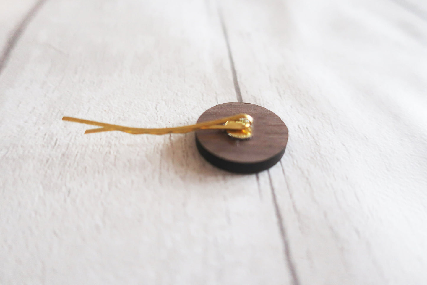 Wooden hairclip back on a white fabric background