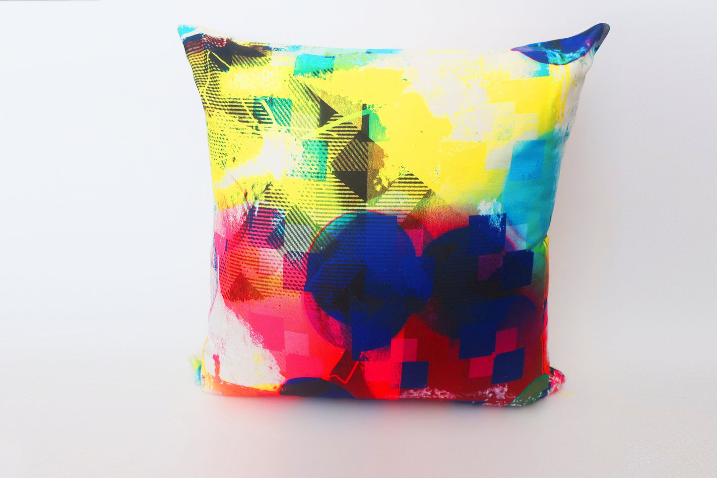 Colorful abstract-patterned pillow on a white background