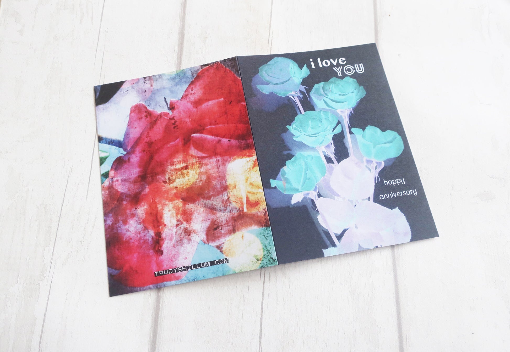 greeting card with floral design on a white wooden surface