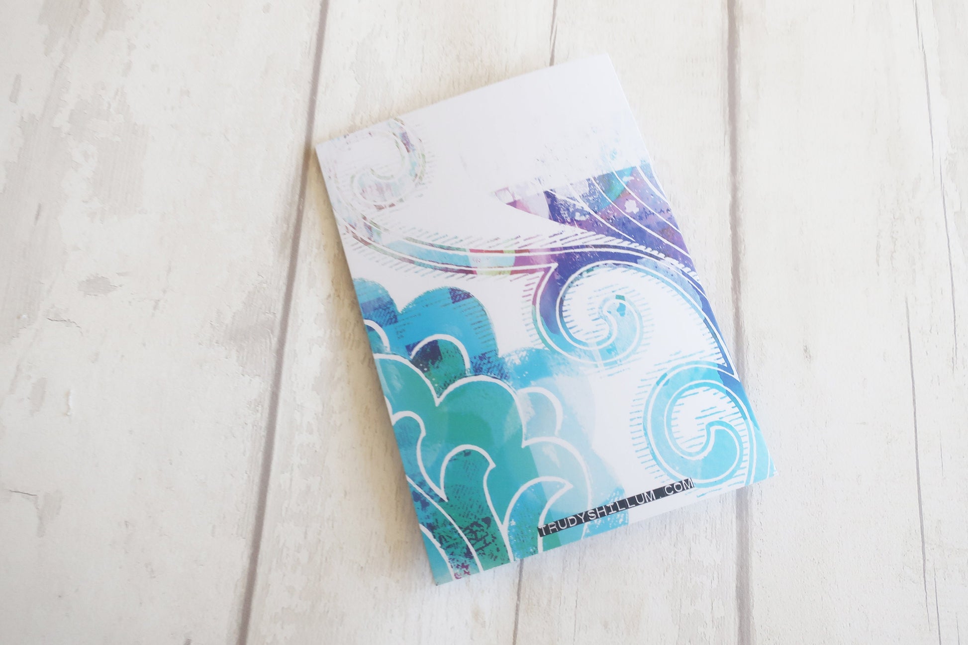 Colorful Greeting card  with abstract design on a light wooden surface