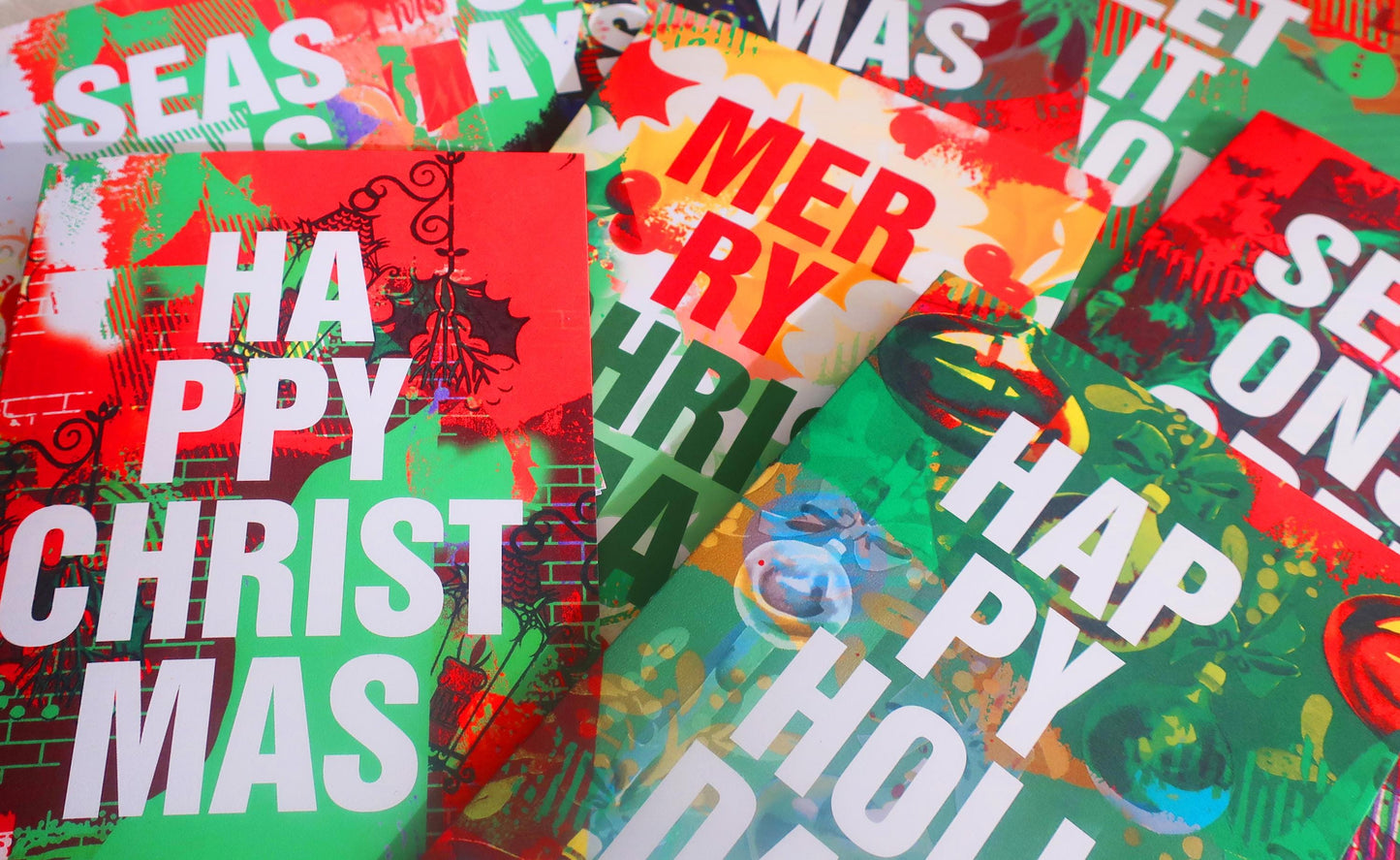 Colorful Christmas-themed paper with 'Happy Christmas' and other festive text.