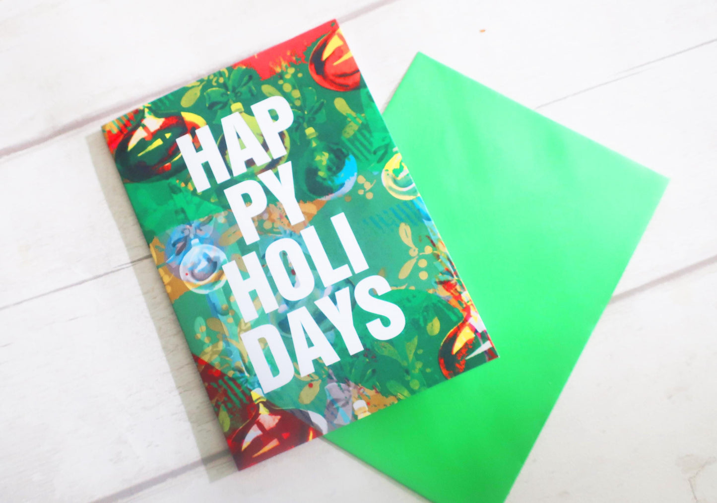 Colorful card with 'Happy Holi Days' text on a white surface