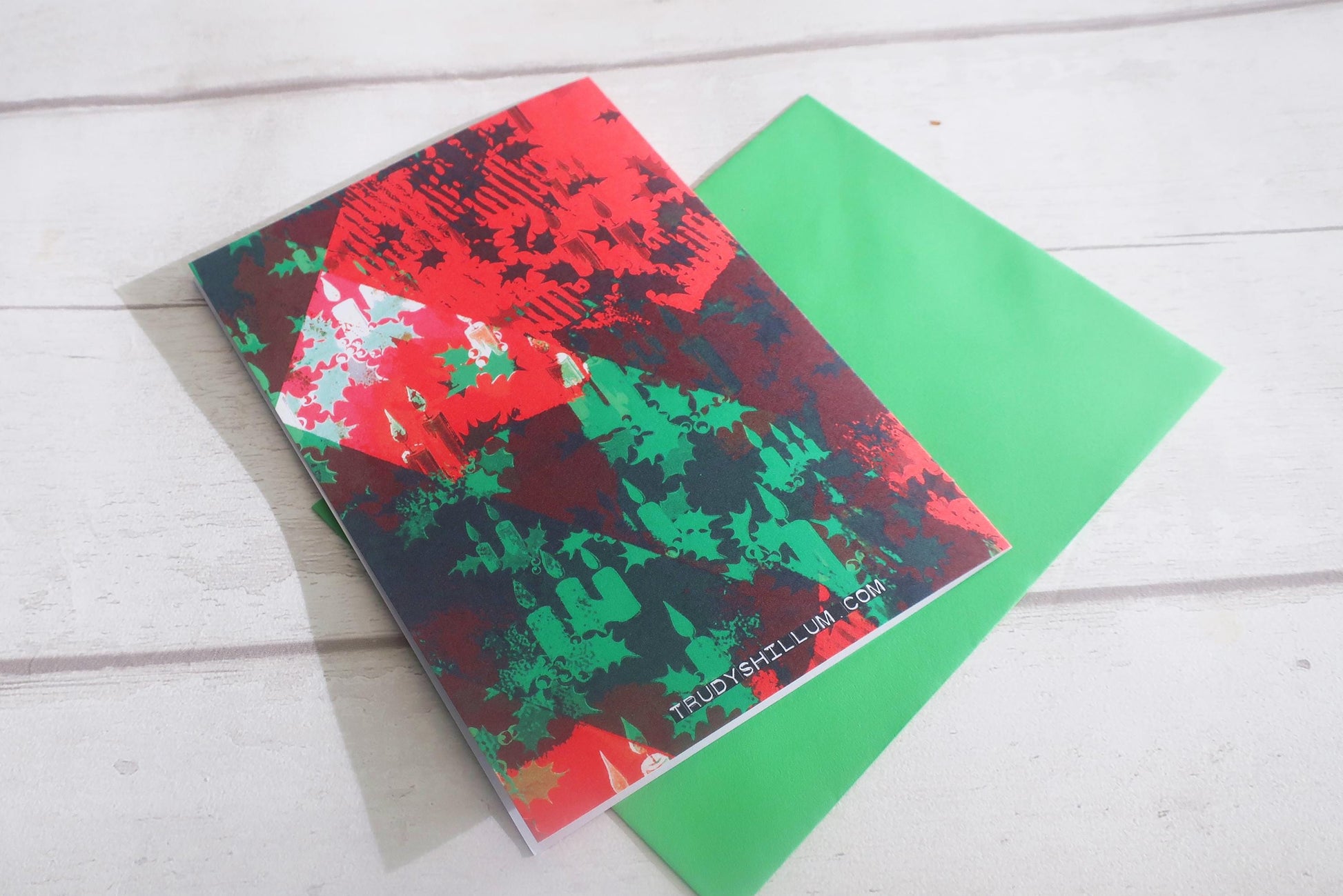 Christmas card with colorful abstract designs on a wooden surface