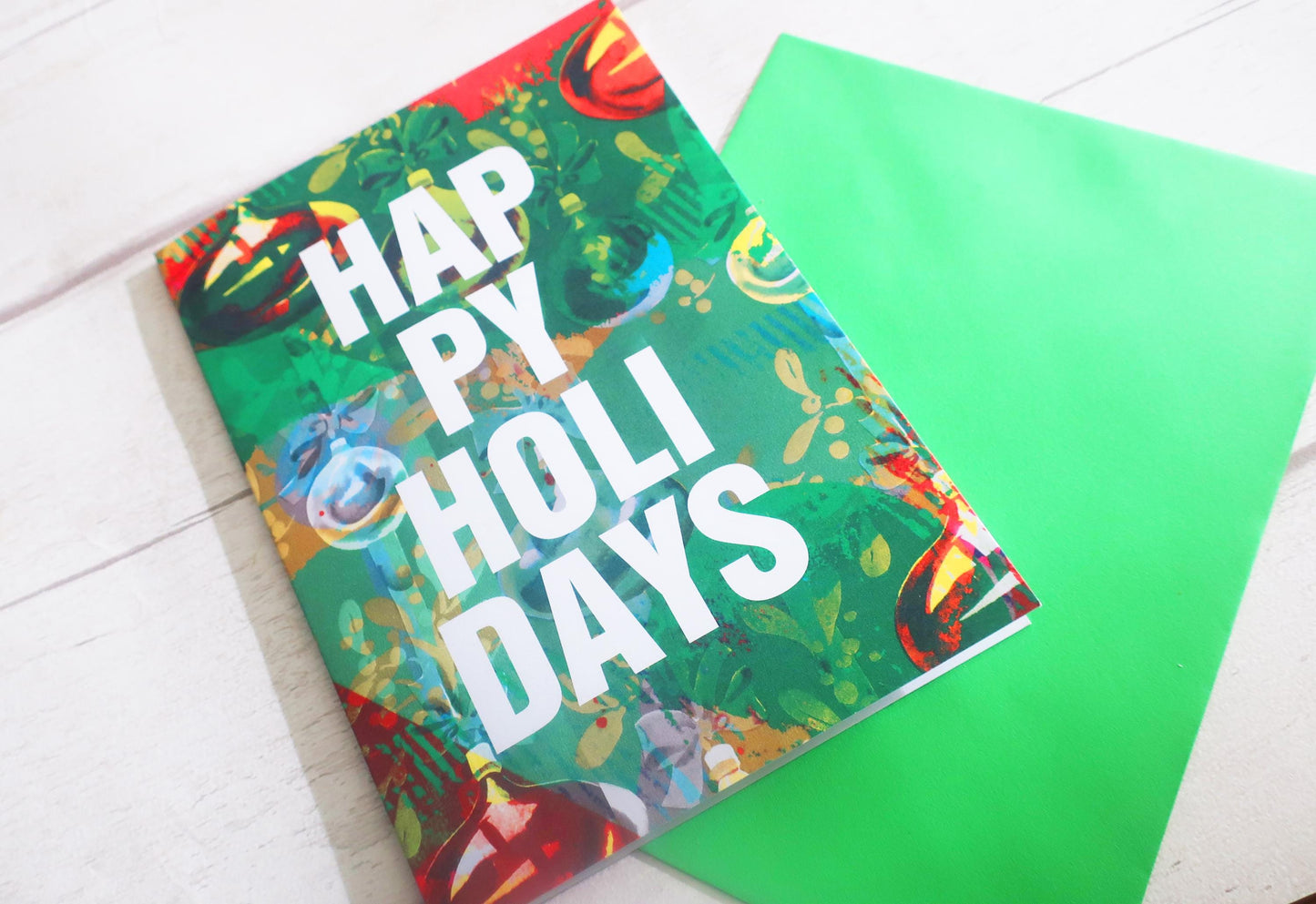 Colorful greeting card with 'Happy Holidays' text on a white surface