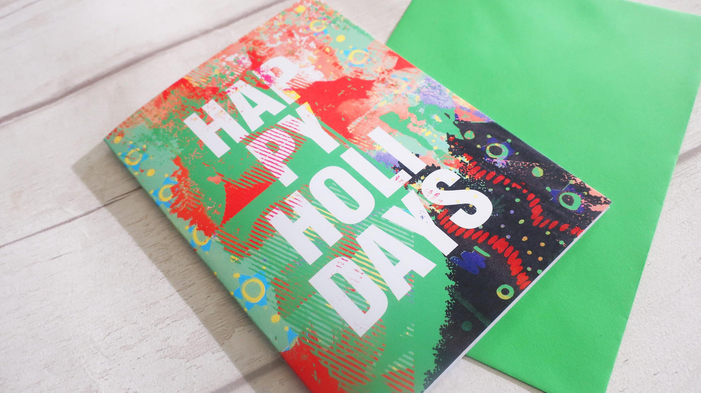 Colorful holiday card with 'Happy Holiday Days' text on a wooden surface