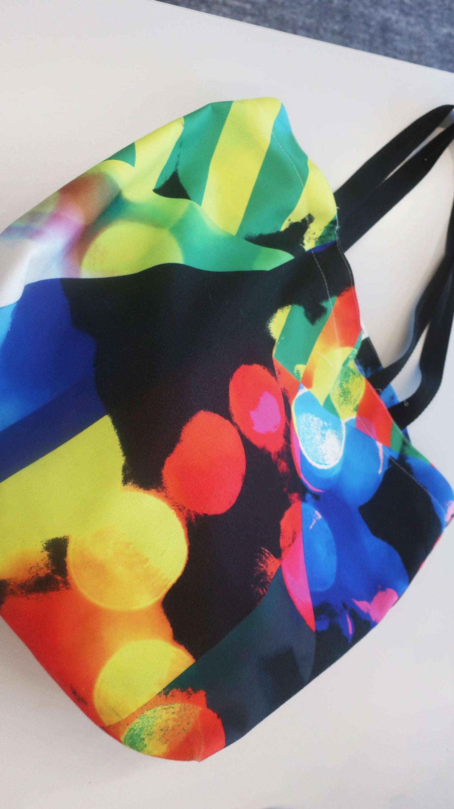 Colorful bag with abstract design on a white surface