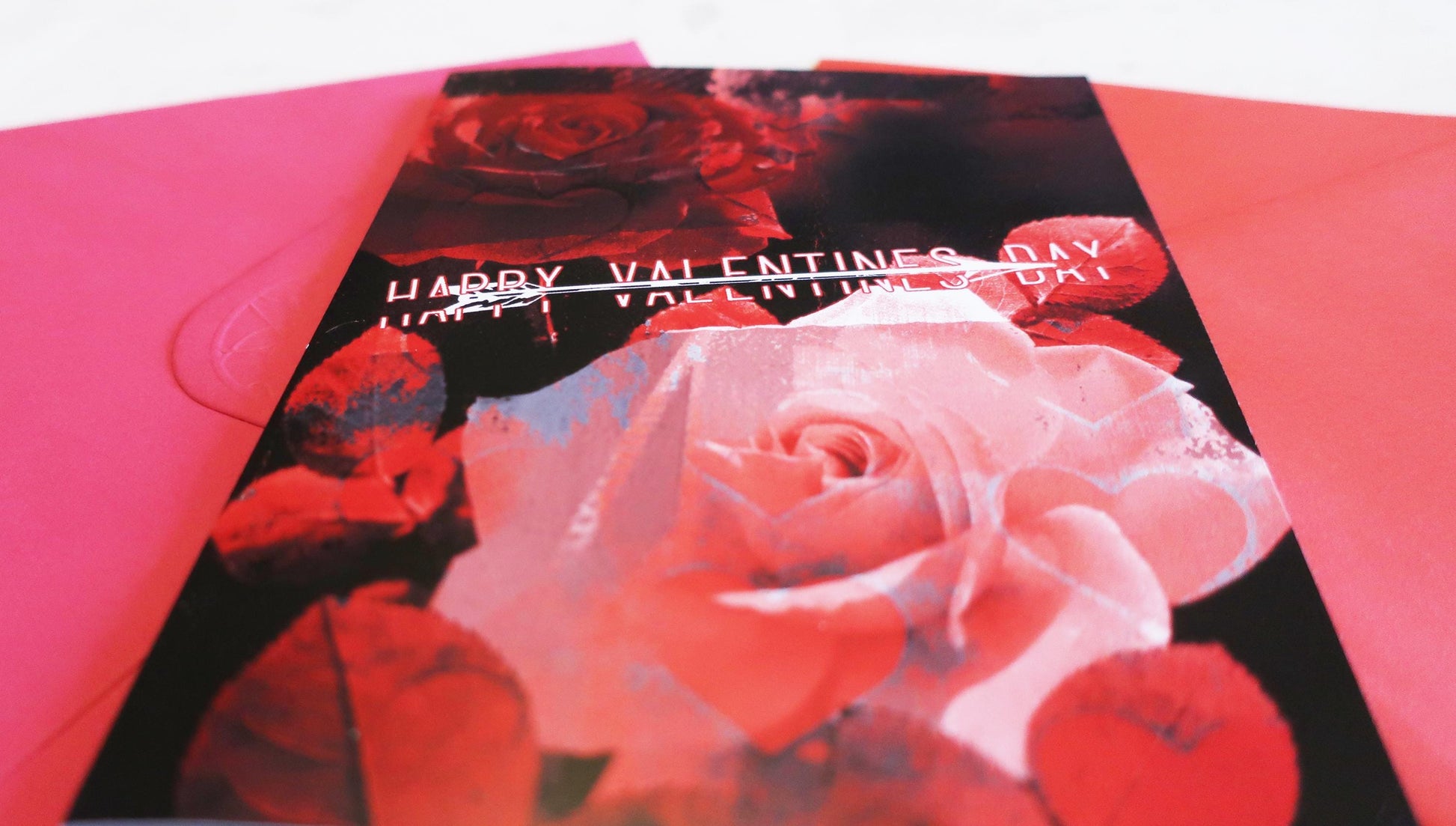 Valentine's Day card with red and pink roses on a white background