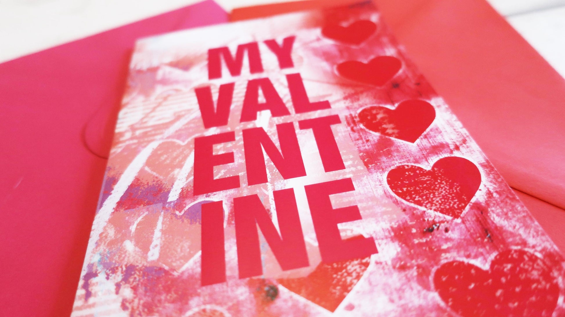Valentine's Day card with 'My Valentine' text and hearts on a red background