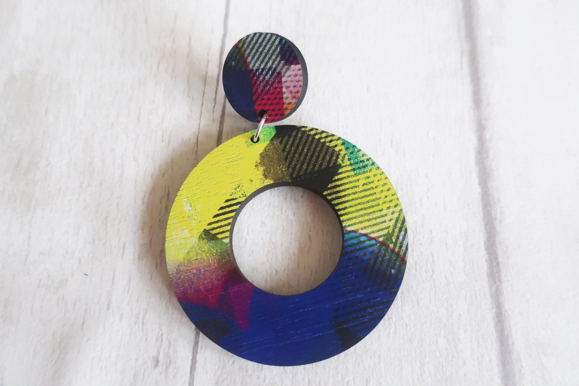 Colorful round earrings on a white background